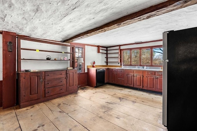 kitchen featuring black dishwasher, open shelves, light countertops, and freestanding refrigerator