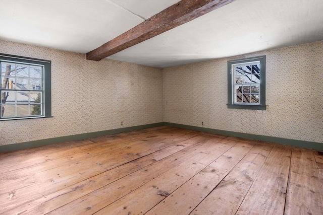 below grade area with hardwood / wood-style flooring and baseboards