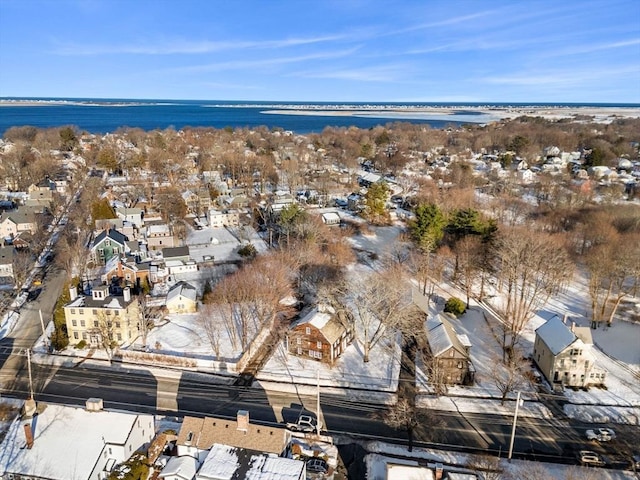 snowy aerial view featuring a residential view and a water view