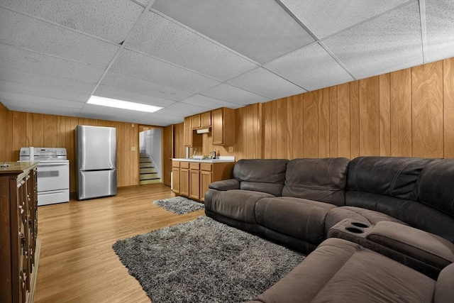 313 Walter St, Fall River, MA 02724 - living room featuring wooden walls, light wood-type flooring, a drop ceiling, and wet bar