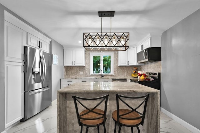 313 Walter St, Fall River, MA 02724 - kitchen with appliances with stainless steel finishes, light marble finish floors, white cabinets, tasteful backsplash, and recessed lighting