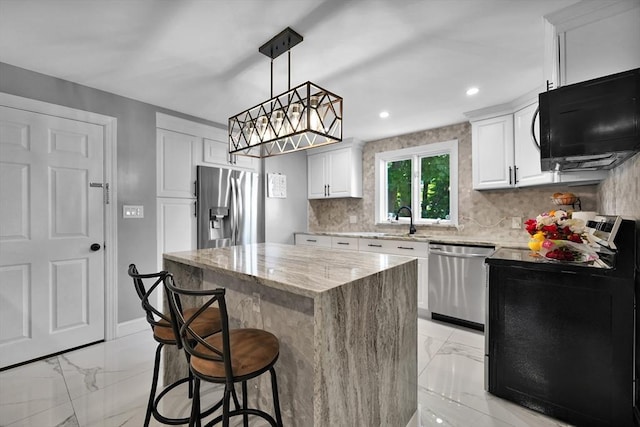 313 Walter St, Fall River, MA 02724 - kitchen featuring black appliances, light marble finish floors, a kitchen island, light stone countertops, and recessed lighting