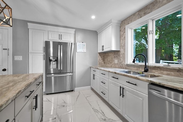 313 Walter St, Fall River, MA 02724 - kitchen with stainless steel appliances, white cabinets, light stone countertops, recessed lighting, and backsplash