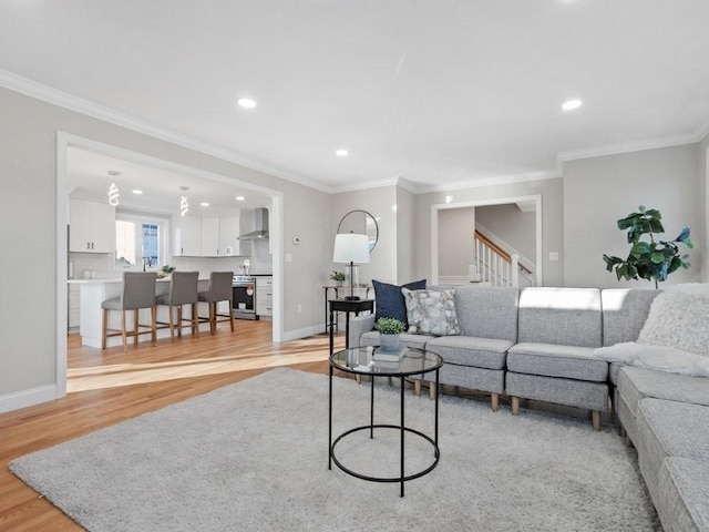 living room with ornamental molding and light wood-type flooring