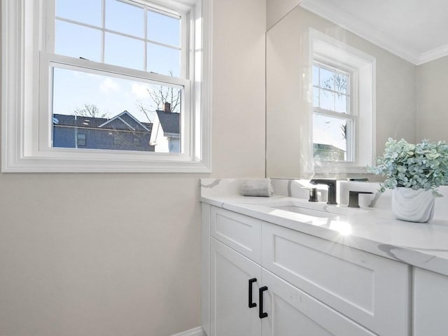 bathroom featuring vanity, a wealth of natural light, and crown molding