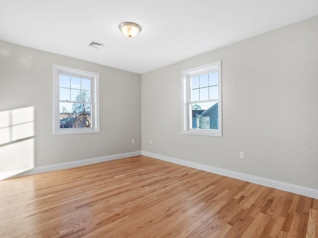 empty room with light hardwood / wood-style flooring