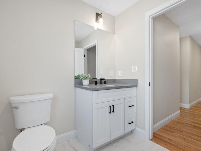 bathroom featuring toilet and vanity