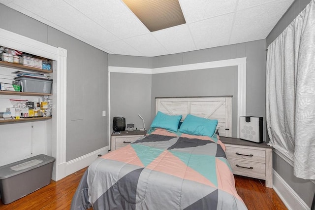 bedroom featuring wood finished floors and baseboards