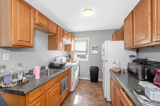 kitchen with dark countertops, white appliances, under cabinet range hood, and brown cabinetry