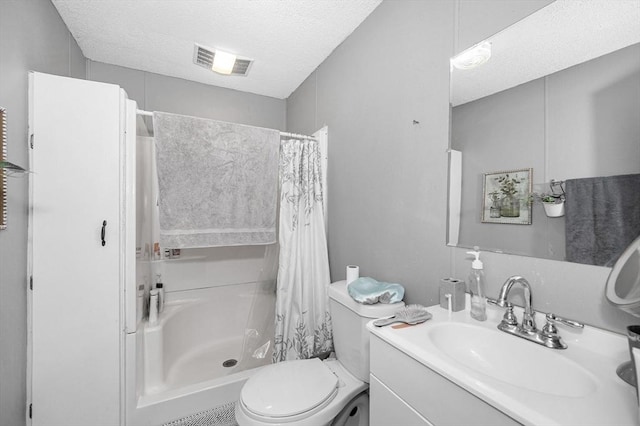 bathroom featuring visible vents, toilet, a textured ceiling, vanity, and a shower stall