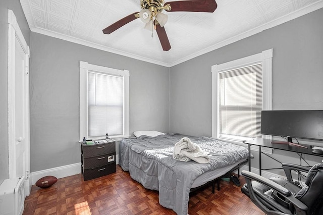 bedroom featuring crown molding, a ceiling fan, and baseboards