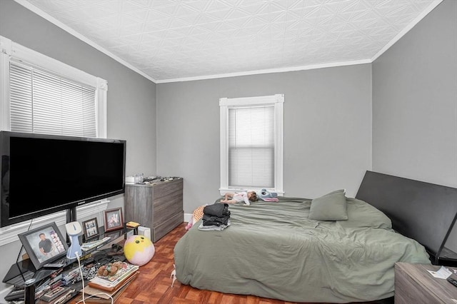 bedroom featuring an ornate ceiling, multiple windows, crown molding, and baseboards