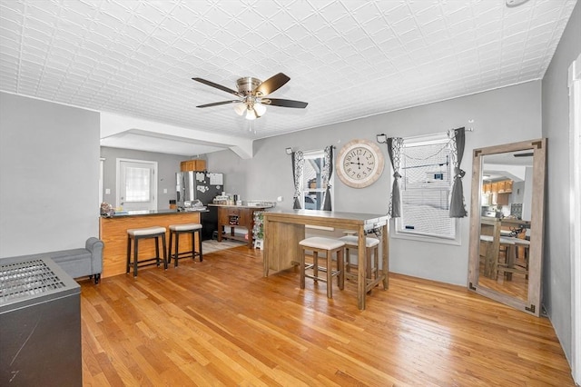 dining room with ceiling fan and wood finished floors