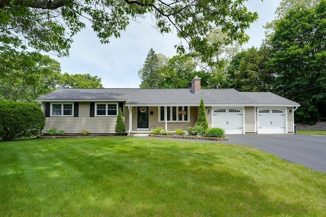 7 Luan Cir, Chelmsford, MA 01824 - single story home featuring an attached garage, asphalt driveway, a chimney, and a front lawn