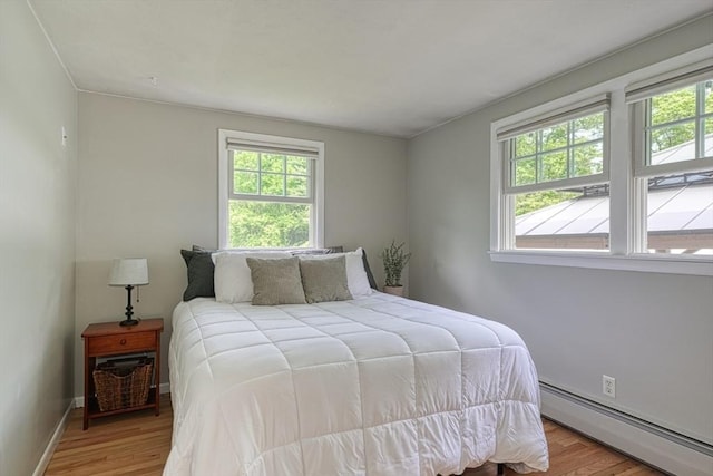 7 Luan Cir, Chelmsford, MA 01824 - bedroom with a baseboard radiator, light wood-style floors, and baseboards