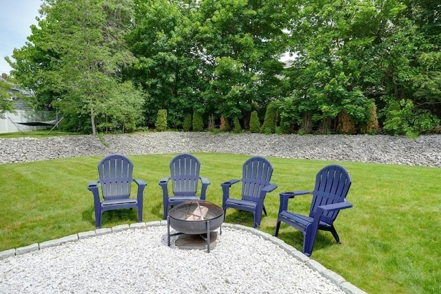 7 Luan Cir, Chelmsford, MA 01824 - view of green lawn featuring an outdoor fire pit and a patio