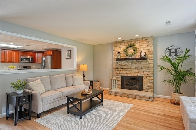 7 Luan Cir, Chelmsford, MA 01824 - living room featuring light wood-style flooring, baseboards, a fireplace, and recessed lighting