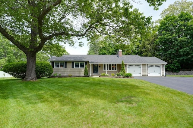 7 Luan Cir, Chelmsford, MA 01824 - ranch-style house featuring a chimney, an attached garage, asphalt driveway, and a front yard