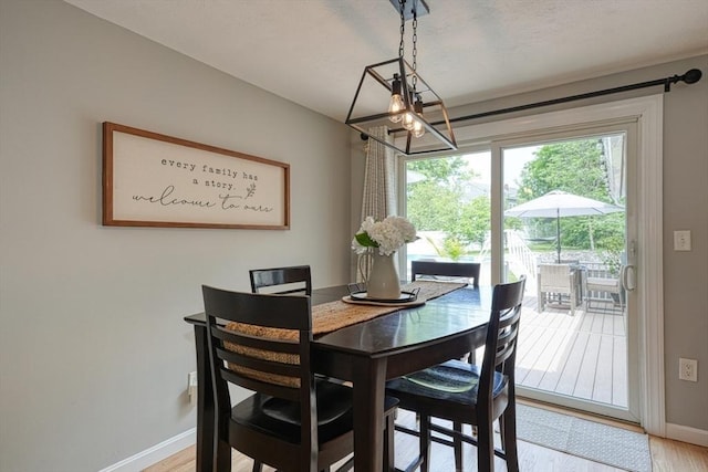 7 Luan Cir, Chelmsford, MA 01824 - dining room with a chandelier, baseboards, and light wood-style flooring