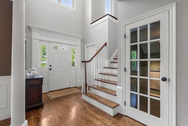 23 Crimson Dr, Shrewsbury, MA 01545 - foyer with a towering ceiling, healthy amount of natural light, wood finished floors, stairs, and decorative columns