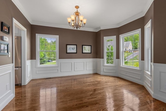 23 Crimson Dr, Shrewsbury, MA 01545 - unfurnished dining area featuring a chandelier, a wainscoted wall, wood finished floors, and ornamental molding