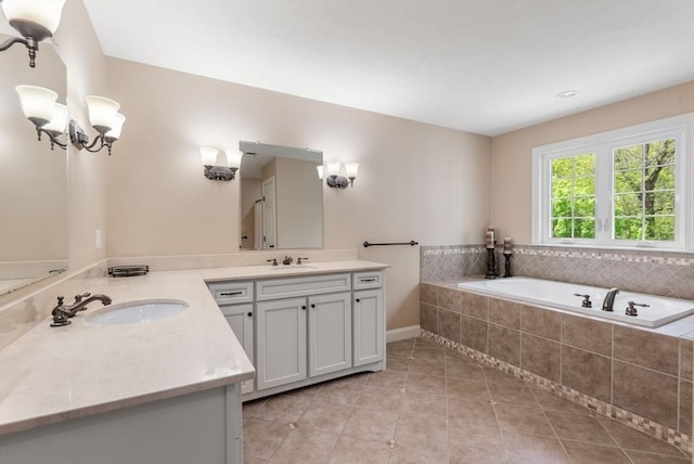 23 Crimson Dr, Shrewsbury, MA 01545 - bathroom with tile patterned flooring, two vanities, a bath, and baseboards