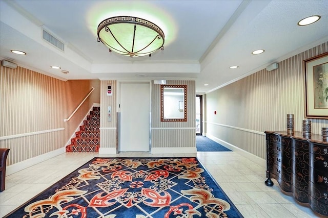 tiled foyer entrance featuring stairway, a tray ceiling, recessed lighting, and ornamental molding