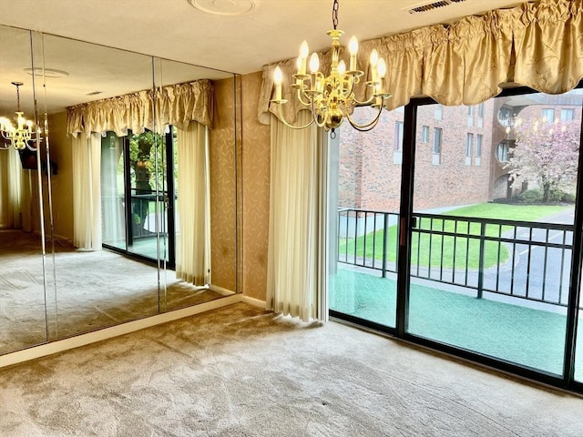 unfurnished dining area with a chandelier and carpet floors