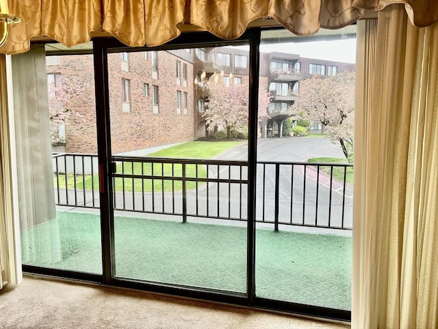 doorway to outside featuring carpet floors