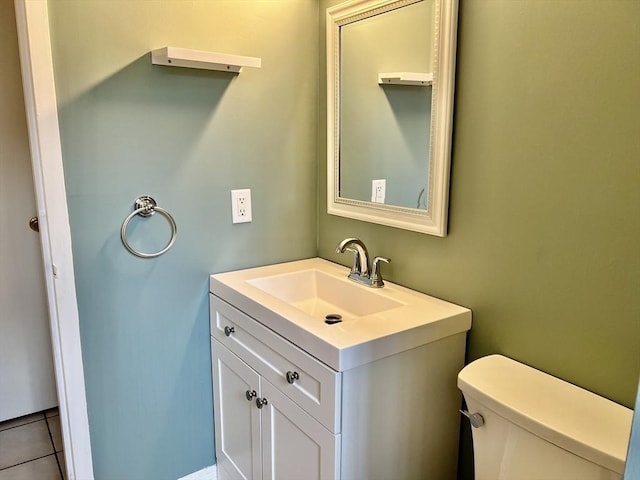 half bathroom featuring vanity and toilet