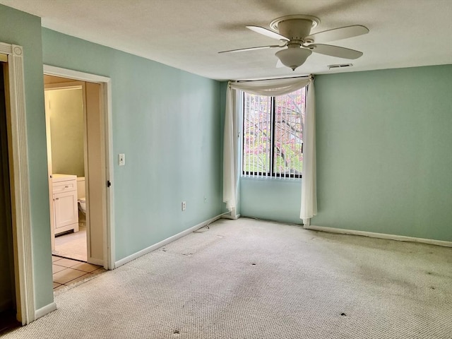 unfurnished room with carpet, ceiling fan, and baseboards