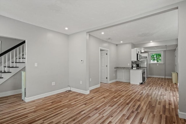 8 Hobson Ave, Worcester, MA 01603 - unfurnished living room featuring light wood-style floors, stairs, and recessed lighting