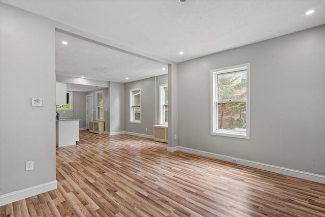 8 Hobson Ave, Worcester, MA 01603 - unfurnished living room with light wood-style floors, recessed lighting, and radiator