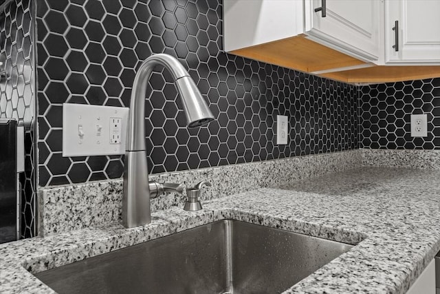 8 Hobson Ave, Worcester, MA 01603 - kitchen view of tasteful backsplash, white cabinets, and light stone countertops