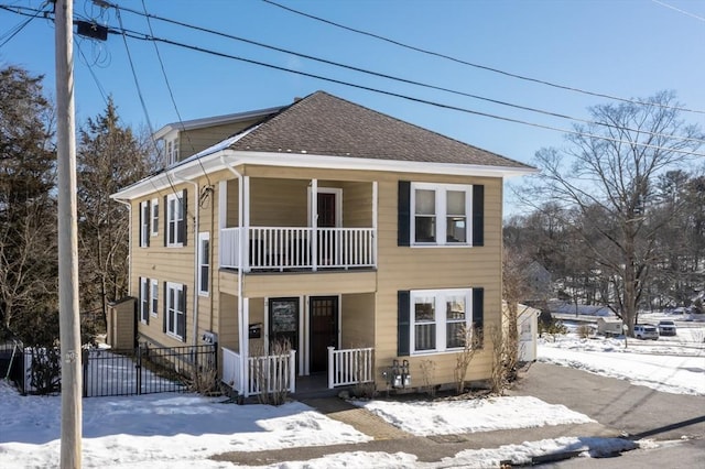 front facade featuring a balcony and a porch