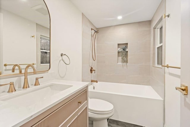 full bathroom featuring toilet, vanity, and tiled shower / bath