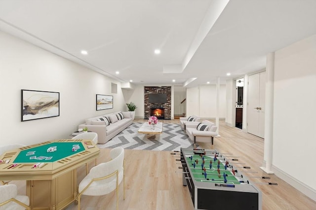 recreation room featuring a fireplace and light hardwood / wood-style floors