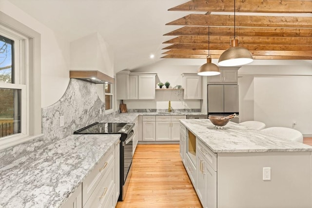 kitchen featuring decorative light fixtures, sink, white cabinets, decorative backsplash, and stainless steel appliances