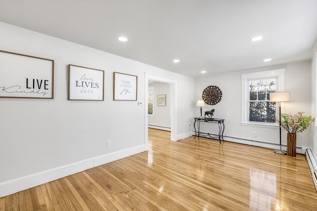 spare room with hardwood / wood-style flooring and baseboard heating