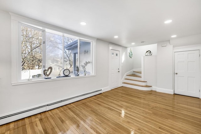 entrance foyer with a baseboard radiator and hardwood / wood-style floors