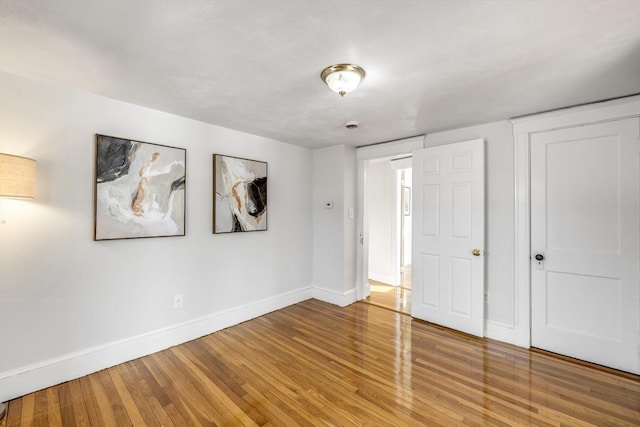 unfurnished bedroom with hardwood / wood-style floors