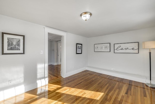 empty room with hardwood / wood-style flooring