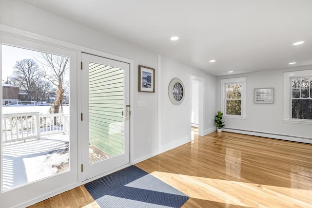 doorway featuring hardwood / wood-style floors and a baseboard radiator