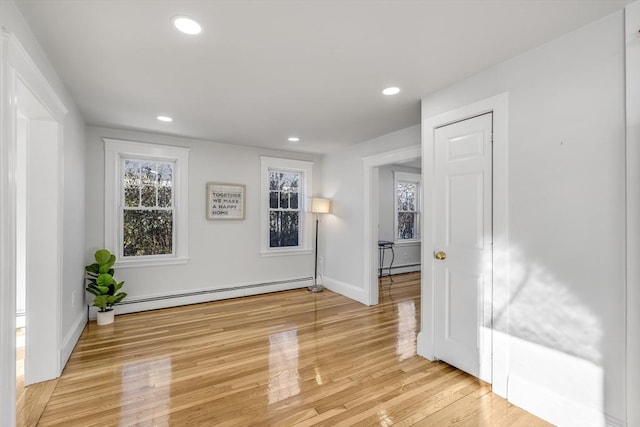 empty room with a baseboard radiator and light wood-type flooring