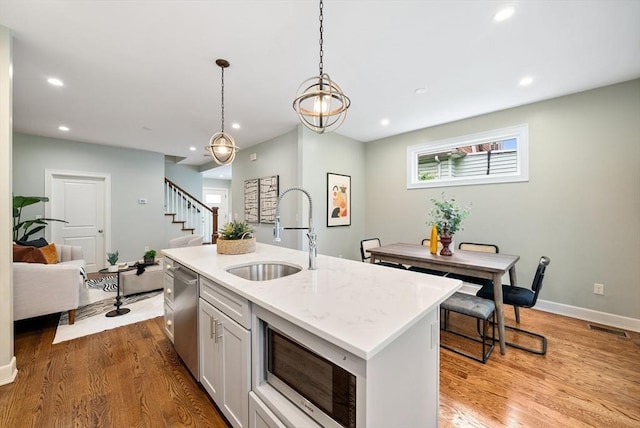 225 Amory St, Boston, MA 02130 - kitchen featuring a sink, appliances with stainless steel finishes, light wood-style flooring, pendant lighting, and recessed lighting
