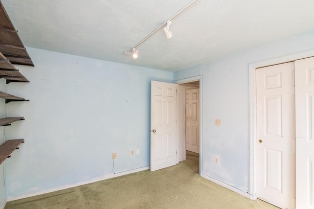 231 Audubon Rd, Northampton, MA 01053 - unfurnished bedroom featuring light colored carpet, track lighting, and baseboards