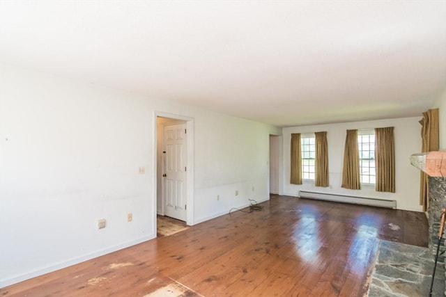 231 Audubon Rd, Northampton, MA 01053 - unfurnished living room featuring baseboard heating, wood finished floors, a fireplace, and baseboards