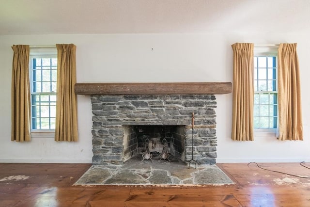 231 Audubon Rd, Northampton, MA 01053 - detailed view of baseboards, wood finished floors, and a stone fireplace