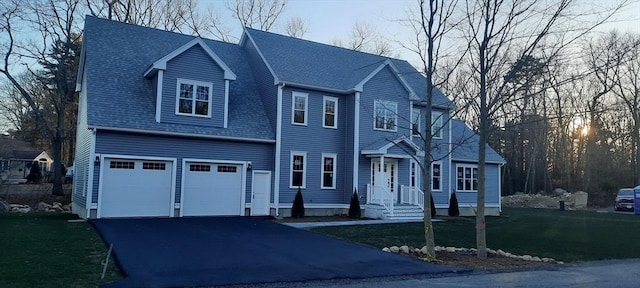 view of front facade with a front yard and a garage