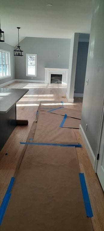 unfurnished living room featuring vaulted ceiling